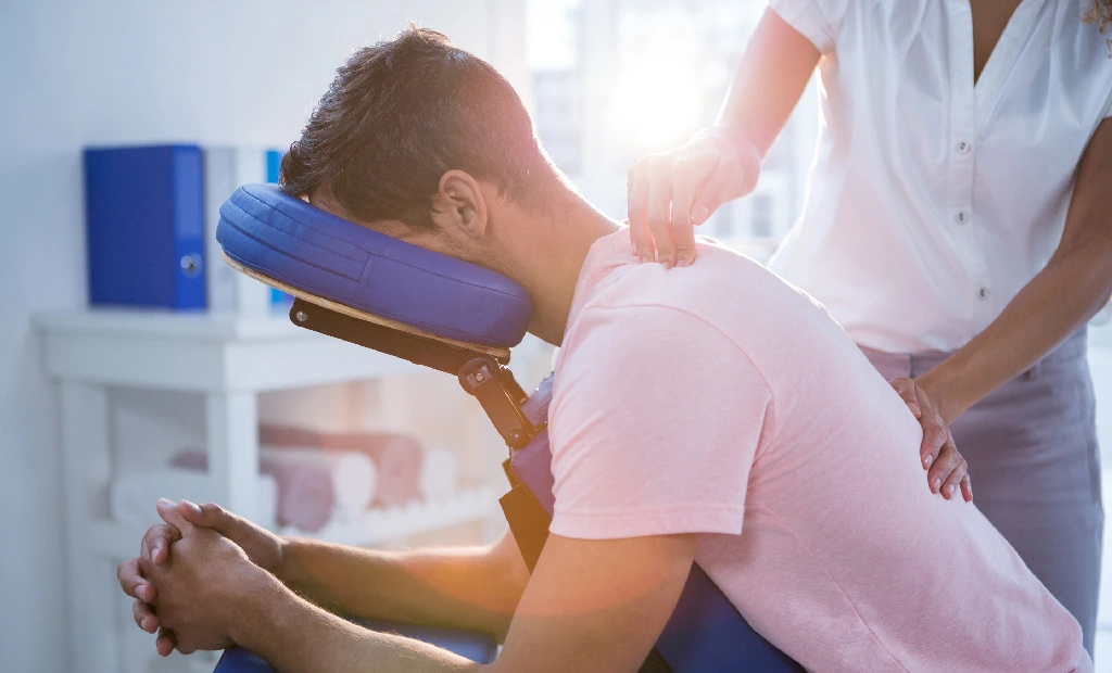 A man is getting his neck adjusted by a doctor.